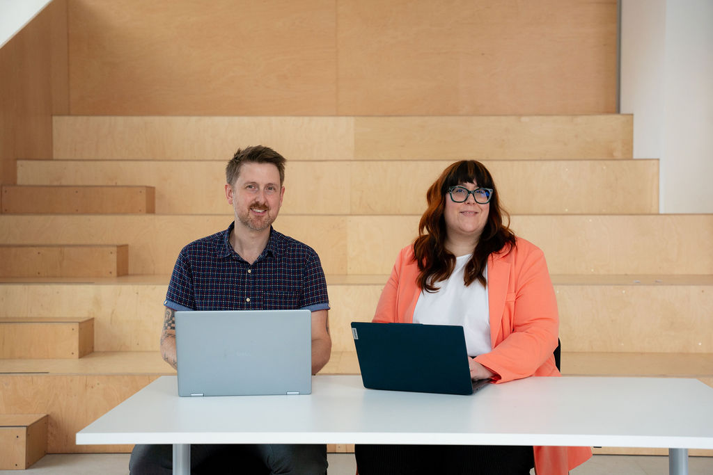 Jeanette working alongside an office manager at their desk